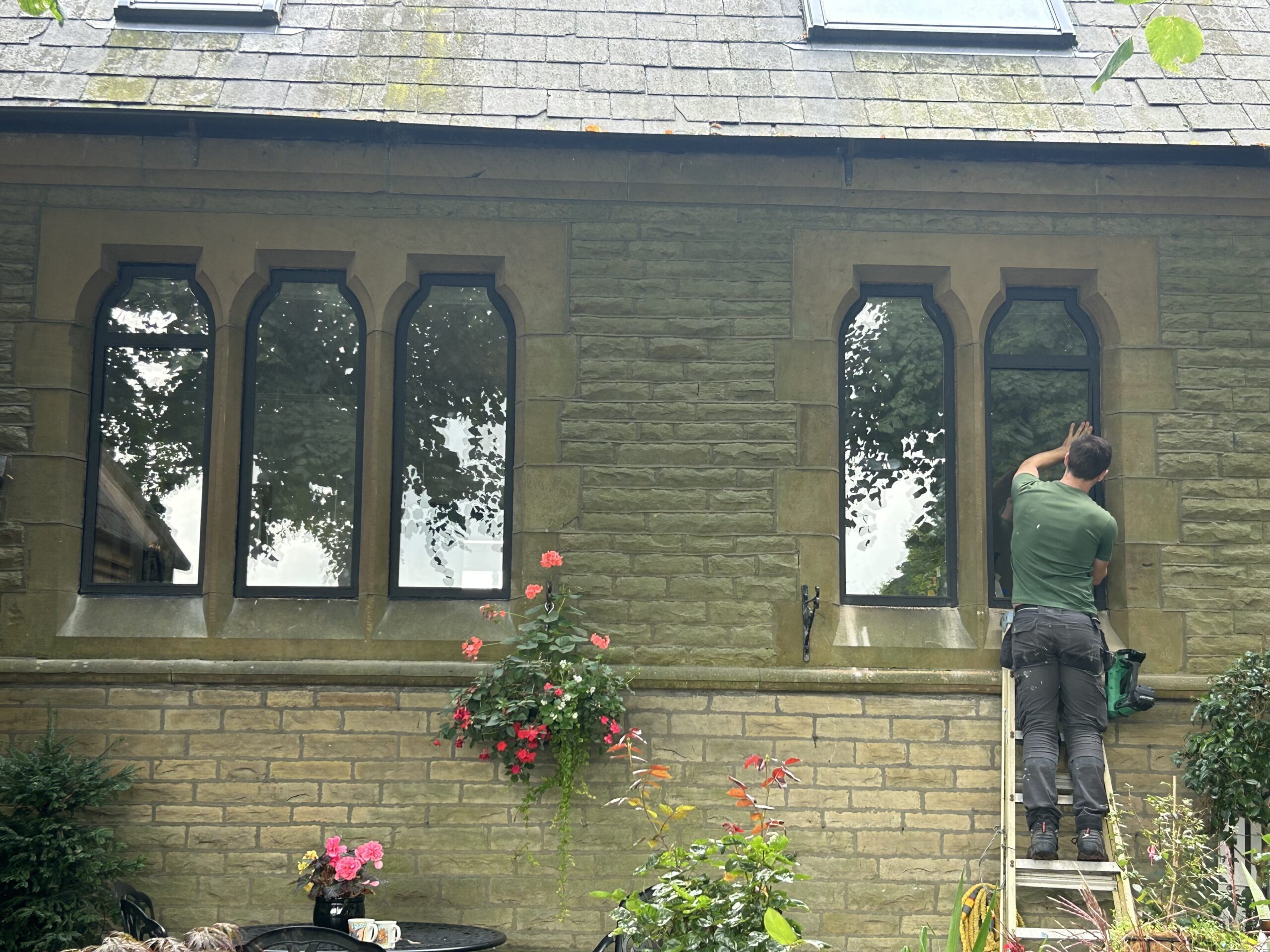 A photo of a joiner fitting windows in a domestic property