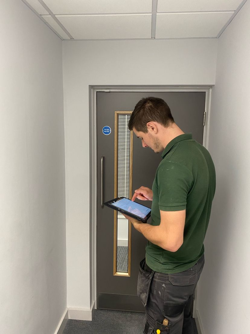 Image of a joiner inspecting a commercial building as part of planned works